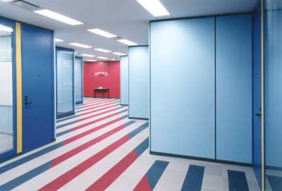 blue and yellow room with red wall and table with strip of red on the floor